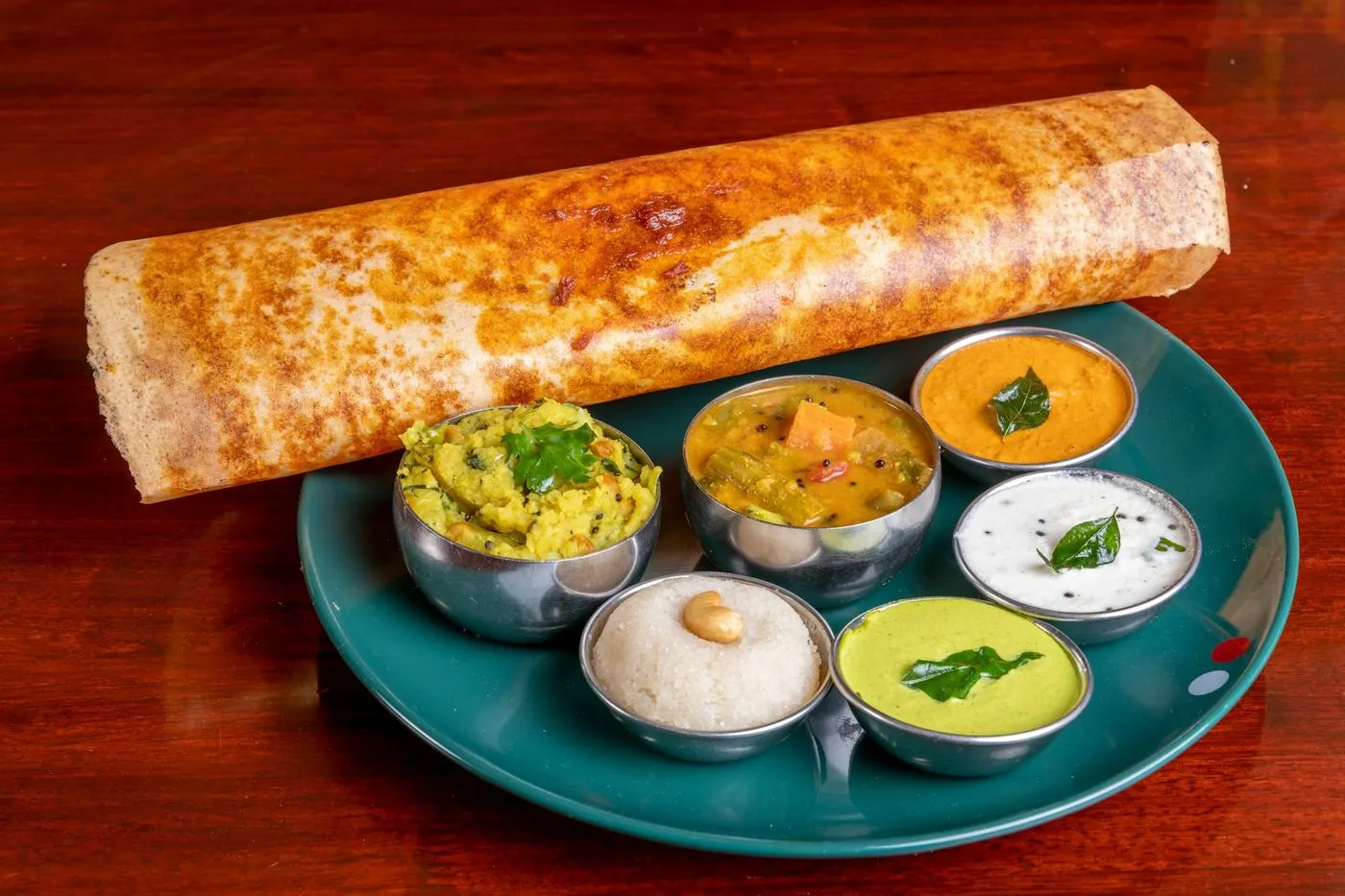 Crispy dosa served with chutneys and sambar
